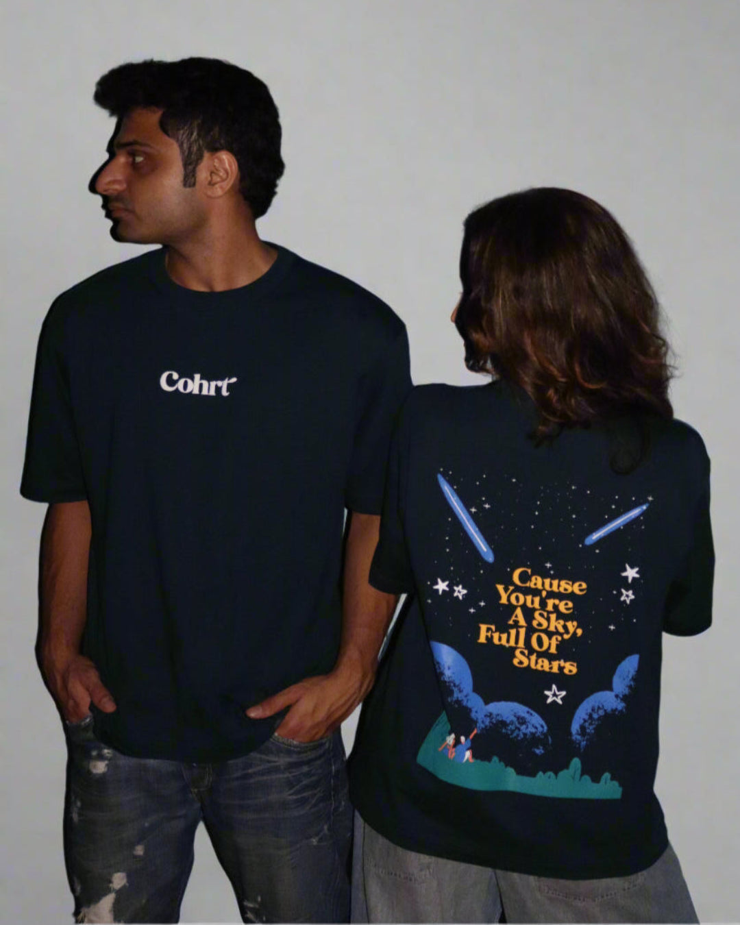 Man and Woman standing wearing a dark blue t-shirt, With Cohrt written in the front and "Cause you're a sky full of stars" written on the back.