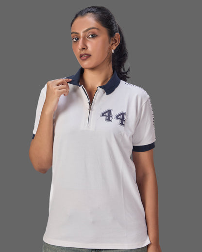 Woman wearing a white polo shirt with through goes hamilton written on the sleeves and 44 in the front  on a plain background