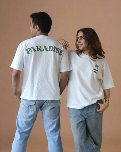 Woman and man standing Wearing white t-shirt and Palm tree on the pocket side and pardise written on the back