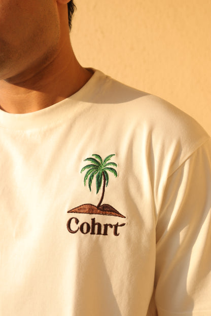 Man standing Wearing white t-shirt and Palm tree on the pocket side 