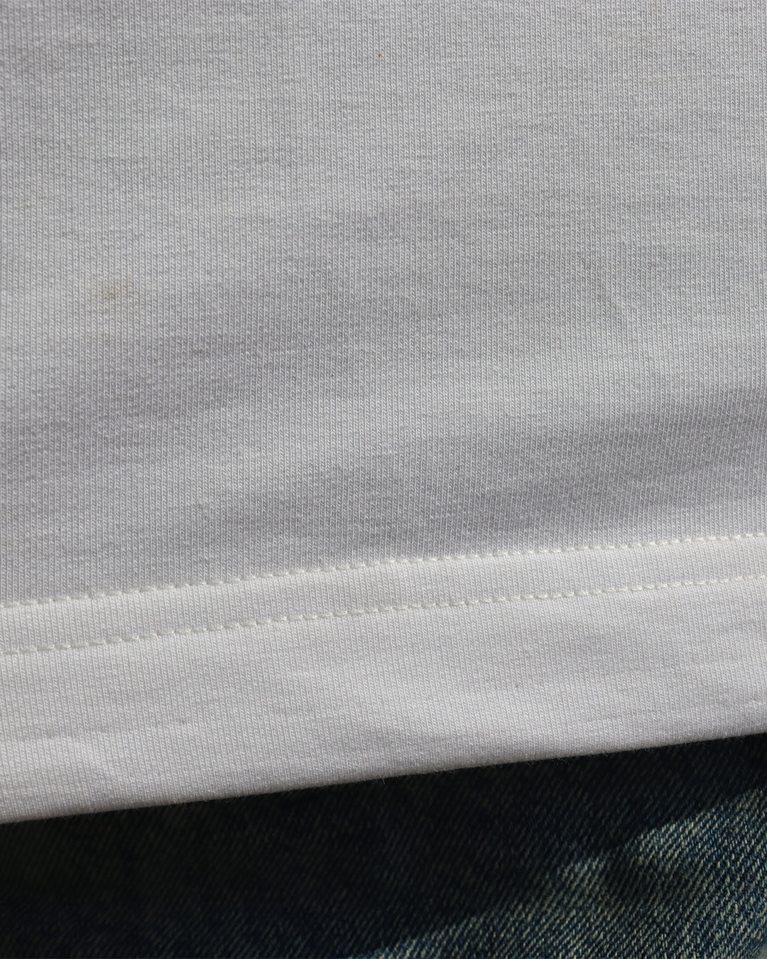 woman wearing white tank top and showcasing the stiches