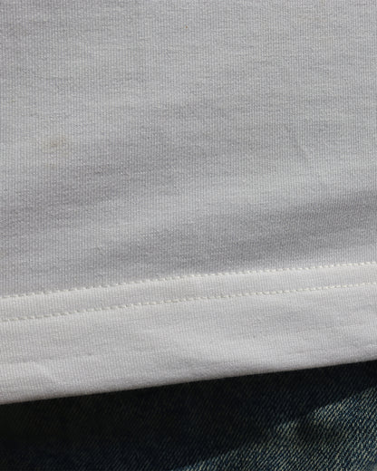 woman wearing white tank top and showcasing the stiches