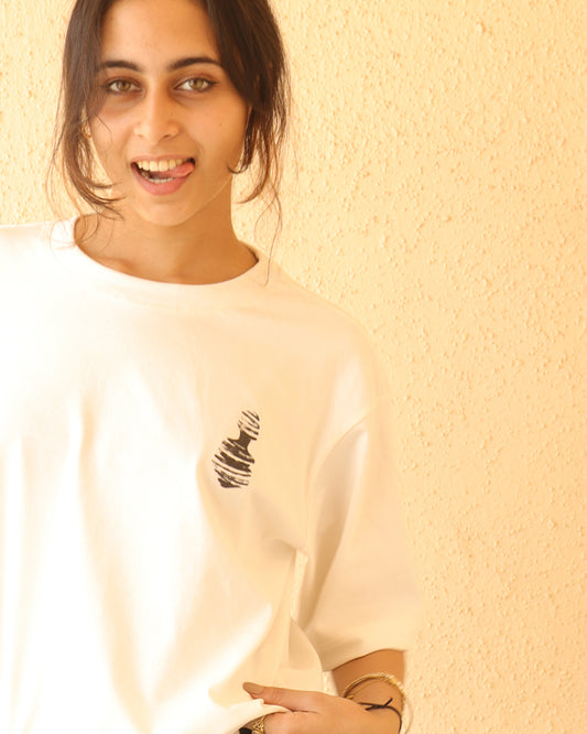 Woman standing wearing a white t-shirt, With a art in the front at the pocket side and art and "nobody said it was easy , its such a shame for us to part" written on the back